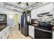 Bright kitchen features stainless steel appliances, granite counters and decorative backsplash at 8823 Aruba Ln, Port Richey, FL 34668