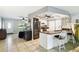 An open concept kitchen featuring stainless steel appliances, counter seating, and modern finishes at 8823 Aruba Ln, Port Richey, FL 34668
