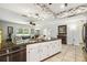 Open concept kitchen features speckled granite counters and bright lighting at 8823 Aruba Ln, Port Richey, FL 34668