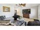 A cozy living room featuring a comfortable sofa, large TV and attractive decor at 8823 Aruba Ln, Port Richey, FL 34668
