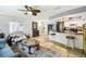Open living space connecting the living room to the kitchen, featuring tile floors and lots of natural light at 8823 Aruba Ln, Port Richey, FL 34668