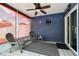 Enclosed patio with ceiling fan, tile floor, roll-down sun shades, and sitting area at 8823 Aruba Ln, Port Richey, FL 34668