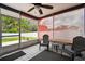 Enclosed patio with tile floor, exterior views, and comfortable outdoor seating at 8823 Aruba Ln, Port Richey, FL 34668