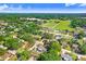 An aerial view showcases the home's location near a local track and field, in a tree-lined residential area at 901 Strawberry Ln, Brandon, FL 33511