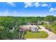 Spacious single-story home with lush surroundings and convenient RV parking, showcased from an aerial perspective at 901 Strawberry Ln, Brandon, FL 33511