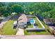 An aerial view shows a private backyard pool, RV parking and manicured lawn in a fenced yard at 901 Strawberry Ln, Brandon, FL 33511