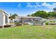 Expansive backyard featuring a pool, garden beds, and a private screened patio, perfect for outdoor living at 901 Strawberry Ln, Brandon, FL 33511