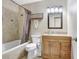 Neutral bathroom featuring a shower and tub combination, single sink vanity, and bronze fixtures at 901 Strawberry Ln, Brandon, FL 33511