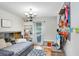 Bedroom with built-in shelves, cozy decor, window views and ceiling fan at 901 Strawberry Ln, Brandon, FL 33511
