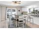 Dining area features table with seating, French doors to backyard, kitchen counter at 901 Strawberry Ln, Brandon, FL 33511
