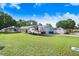 Expansive front yard with an RV parked on the side, showcasing the property's ample outdoor space at 901 Strawberry Ln, Brandon, FL 33511