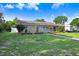 Inviting single-story stone home with a well-maintained lawn and convenient RV parking at 901 Strawberry Ln, Brandon, FL 33511
