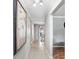 Inviting hallway with tile flooring, crown molding, and a glimpse into the dining area at 901 Strawberry Ln, Brandon, FL 33511