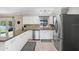 Kitchen showcases granite counters, white cabinets, and stainless steel appliances at 901 Strawberry Ln, Brandon, FL 33511