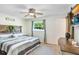 Comfortable main bedroom with hardwood floors, and a window view to lush outdoor greenery at 901 Strawberry Ln, Brandon, FL 33511
