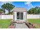 Charming pool house with sliding glass doors and adjacent raised garden beds at 901 Strawberry Ln, Brandon, FL 33511