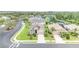 An aerial view showcases a lovely home in a neighborhood near a scenic pond surrounded by lush greenery at 9067 39Th Street E Cir, Parrish, FL 34219