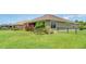 This backyard features a grassy area, plants and a fence at 9067 39Th Street E Cir, Parrish, FL 34219