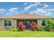 The backyard features a grassy area, plants, fence and screened lanai at 9067 39Th Street E Cir, Parrish, FL 34219