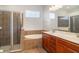 Bathroom showcasing a soaking tub, glass-enclosed shower, and dual vanities at 9067 39Th Street E Cir, Parrish, FL 34219