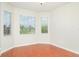 This bedroom features hardwood floors, a large window and white trim at 9067 39Th Street E Cir, Parrish, FL 34219