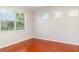 Bright bedroom with wood floors and natural light from large windows at 9067 39Th Street E Cir, Parrish, FL 34219
