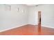 Light-filled bedroom with wood floors and a view to the bathroom at 9067 39Th Street E Cir, Parrish, FL 34219
