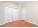 This bedroom features hardwood floors, a closet and a door at 9067 39Th Street E Cir, Parrish, FL 34219