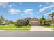 Beautiful single-story home with a well-manicured lawn and lush landscaping in a suburban neighborhood at 9067 39Th Street E Cir, Parrish, FL 34219