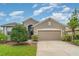 Charming single-Gathering home features a manicured lawn, mature landscaping, and an attached two-car garage at 9067 39Th Street E Cir, Parrish, FL 34219
