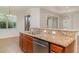 Kitchen counter area with a stainless steel dishwasher and granite countertops at 9067 39Th Street E Cir, Parrish, FL 34219