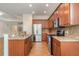 Bright kitchen featuring stainless steel appliances, granite countertops, and tile flooring at 9067 39Th Street E Cir, Parrish, FL 34219