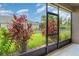 This lanai features a view of the backyard and a decorative plant at 9067 39Th Street E Cir, Parrish, FL 34219