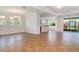An expansive living area boasts tile flooring, crown molding, and access to an outdoor patio with a sliding glass door at 9067 39Th Street E Cir, Parrish, FL 34219