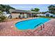 Backyard oasis features a covered patio, in-ground pool, and ample space for outdoor enjoyment at 11236 116Th St, Largo, FL 33778
