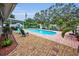 Relaxing backyard with in-ground pool, covered patio, and low-maintenance gravel landscaping at 11236 116Th St, Largo, FL 33778