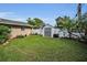Well-maintained backyard with shed, lush green lawn, and privacy fence, perfect for outdoor activities at 11236 116Th St, Largo, FL 33778