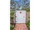 Private white fence and custom gate lead to a private outdoor space at 11236 116Th St, Largo, FL 33778