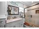 Bathroom featuring a walk-in shower and a vanity with a granite countertop at 11236 116Th St, Largo, FL 33778