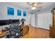 Office with monitors, desk, wood floor, ceiling fan and windows with blinds at 11236 116Th St, Largo, FL 33778