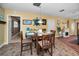Charming dining area adjacent to living room with tiled floor, round table and easy access to outside at 11236 116Th St, Largo, FL 33778