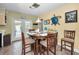 Cozy dining area with tiled flooring, round wooden table with seating for four, and natural lighting at 11236 116Th St, Largo, FL 33778