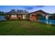 Charming brick home with manicured lawn, palm trees, dark shutters, and a painted driveway at 11236 116Th St, Largo, FL 33778