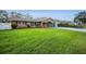 Charming brick home featuring a well-manicured lawn, a painted driveway, and dark shutters at 11236 116Th St, Largo, FL 33778