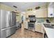 Well-lit kitchen with stainless steel refrigerator and oven at 11236 116Th St, Largo, FL 33778