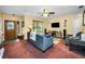 Cozy living room with a plush sofa, ample natural light, and a decorative ceiling fan at 11236 116Th St, Largo, FL 33778
