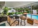 Outdoor patio featuring a seating area, bar-style table, and access to a refreshing pool at 11236 116Th St, Largo, FL 33778