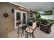 Cozy outdoor patio featuring comfortable seating and a bar-style table at 11236 116Th St, Largo, FL 33778