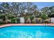 Inviting in-ground pool with brick patio and lush landscaping creates a private backyard oasis at 11236 116Th St, Largo, FL 33778