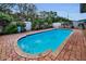 Inviting in-ground pool surrounded by a brick patio and lush greenery in a private backyard at 11236 116Th St, Largo, FL 33778